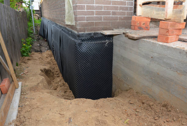 Happy homeowners after waterproofing job in East Rochester